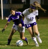Lemoore's Arlene Rizo battles for the ball during the first half of Tuesday's soccer match against visiting Mission Oaks. The Lady Tigers fell 6-0 to the visiting Hawks.